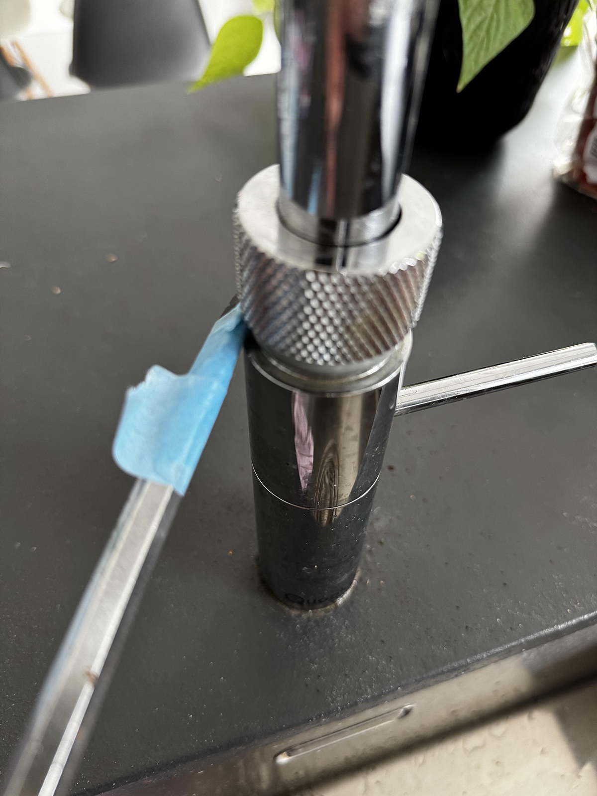 Apply tape to the screwdriver to avoid scratching the tap